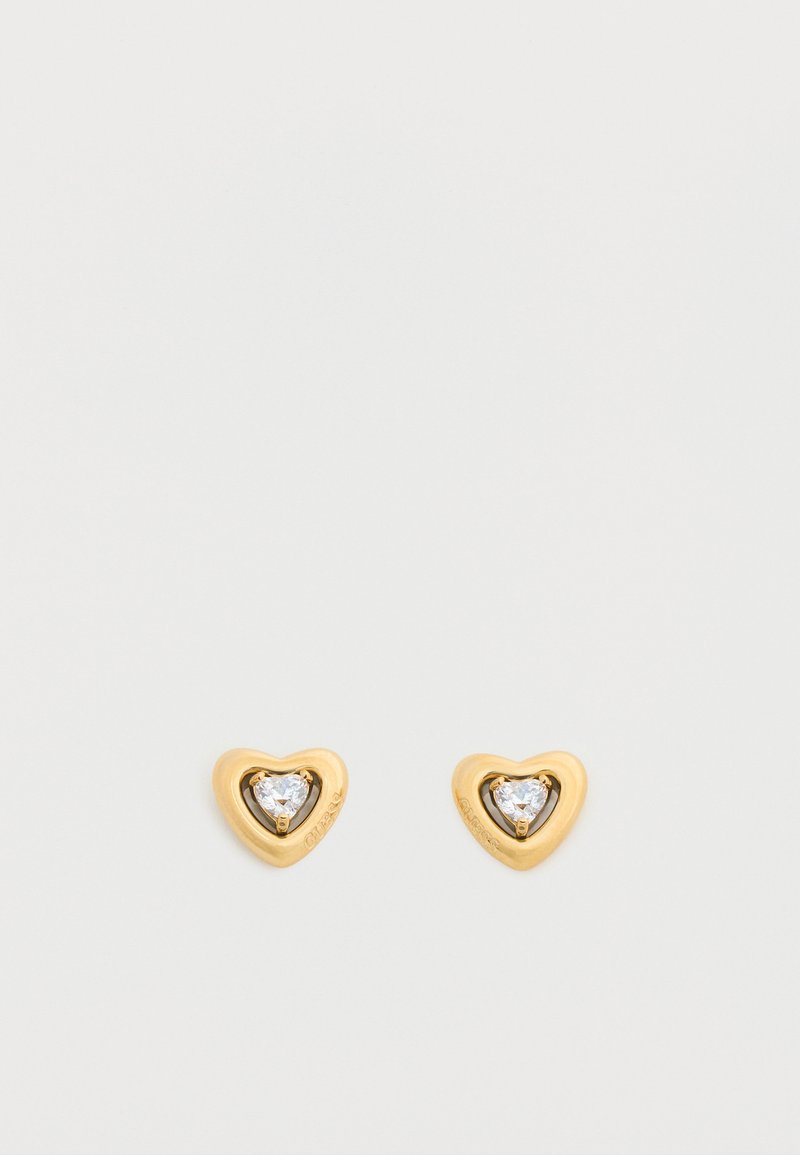 Χρυσά καρφωτά σκουλαρίκια σε σχήμα καρδιάς, το καθένα με μια μικρή διαυγή καρδιά από πολύτιμο λίθο στο κέντρο.