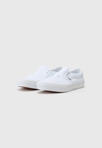 Valged kanva slip-on kingad kummist tallaga, ümarate varvastega, elastsete külgpindadega ja peene brändinguga ülaserval.