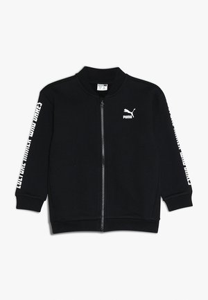 Mustapukuinen vetoketjullinen takki, joka on valmistettu pehmeästä kankaasta. Varustettu joustinyksiköillä ja valkoisella Puma-logolla sekä tekstillä hihoissa. Yksinkertainen, virtaviivainen muotoilu.