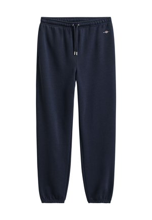 Pantalones deportivos azul marino con cintura elástica, cordón, bolsillos laterales, puños elásticos y pequeño logo blanco en la cadera izquierda.