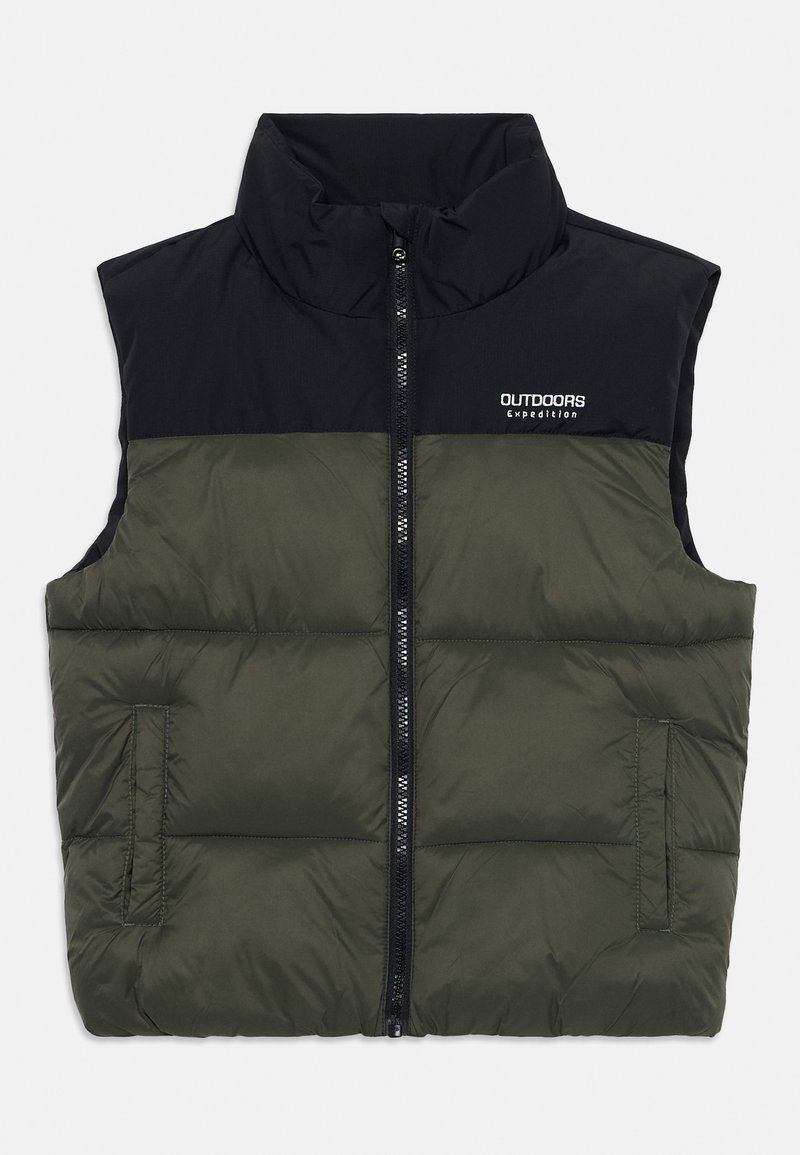 Pufota vesta ar melnu augšējo daļu un olīvzaļo apakšējo daļu. Ar rāvējslēdzēju, augstu apkakli un sānu kabatām. "OUTDOORS Expedition" uzņēmuma logo.