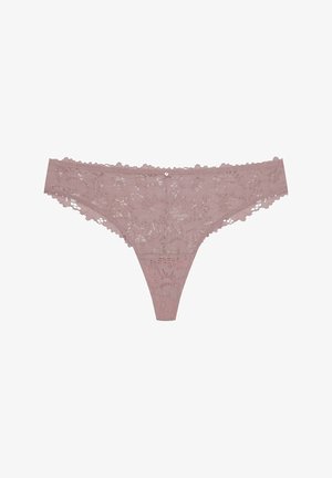 Lace thong in soft pink, featuring floral patterns, scalloped edges, and a small decorative accent at the center front.