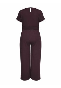 Bordeaux overal s krátkymi rukávmi a výrezom na chrbte, s priliehavým pásom a širokými nohavicami. Textúrovaná látka.