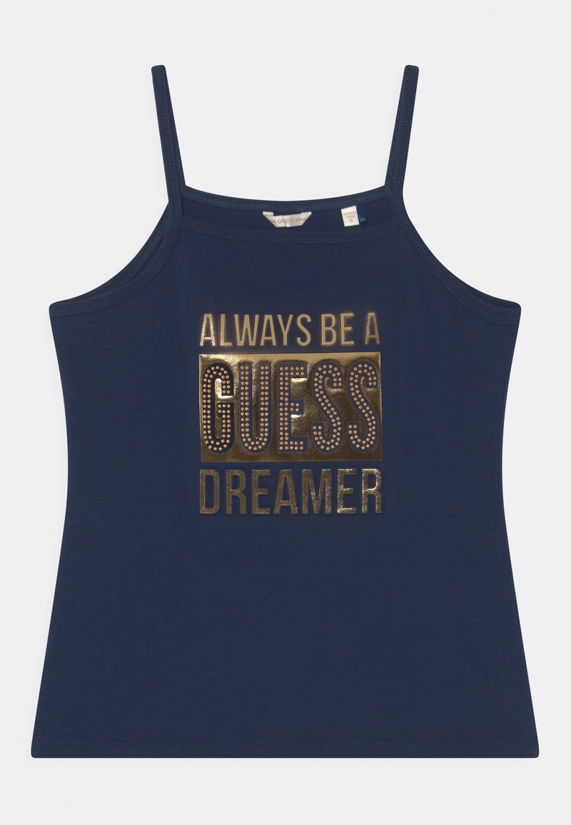 Haut sans manches bleu marine avec fines bretelles, présentant un texte doré et des clous formant l'inscription "Always be a GUESS Dreamer" sur le devant.