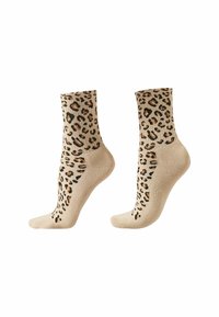 Beiga ankelsockor med ett leopardmönster i svart och brunt. Texturerat stickat material och förstärkt mudd för hållbarhet.