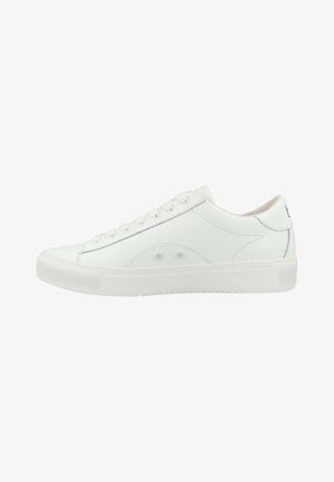 White leather sneaker with a rounded toe, textured upper, six eyelets, and a flat rubber sole. Features minimalist stitching and perforations.