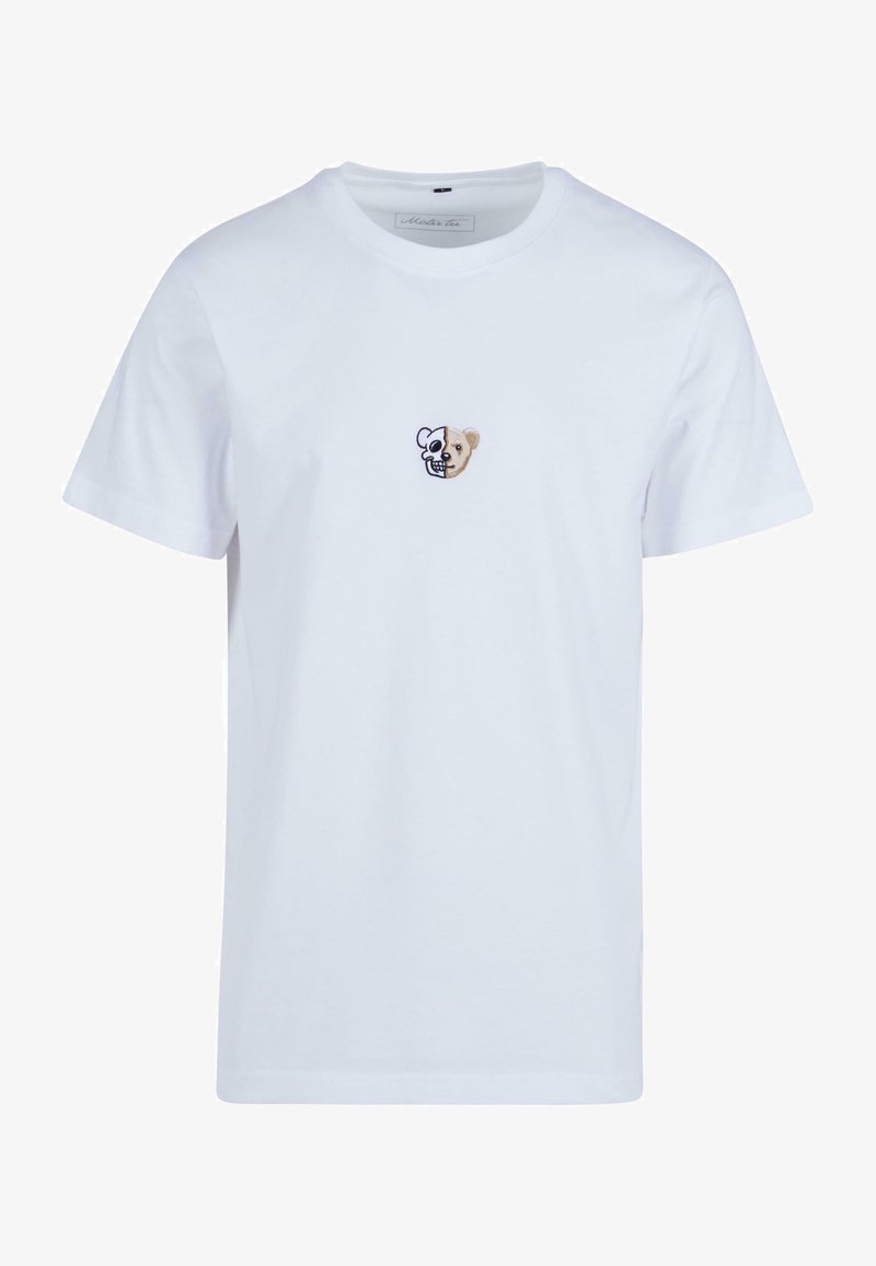 Balta medvilninė marškinėlių suapvalintu kaklu, trumpomis rankovėmis, su maža siuvinėta pusiau kaukolės ir pusiau meškos veido dizainu.