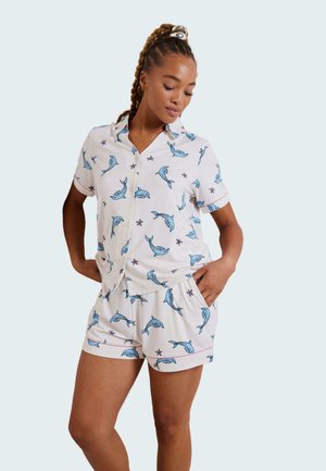 Short-sleeve pajama set in white fabric, featuring blue dolphin and starfish prints, with a collared shirt and elastic waist shorts.
