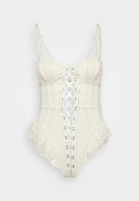Crème kleurige kant bodysuit met verstelbare bandjes, kantafwerking en een voorzijde met vetersluiting met satijnen lint en metalen oogjes.