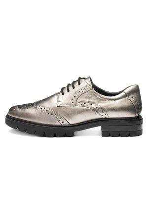 Men's metallic silver leather brogue shoe with wingtip detailing, black laces, and thick black rubber sole.