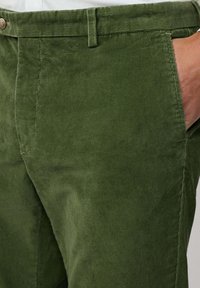 Groene corduroy broek met een rechte snit, gestructureerde stof met verticale ribbels en zijzakken. Metalen knoopsluiting bij de taille.