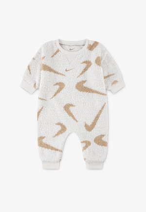 Bílý fleecový overal s hnědými vzory loga Nike, žebrovanými manžetami a kulatým výstřihem. Měkká textura a volný střih, vhodný pro kojence.