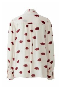 Langarmbluse aus leichtem Stoff, mit rot und grau gefärbten lippenförmigen Flecken auf einem cremefarbenen Hintergrund, klassischem Kragen und geknöpften Manschetten.