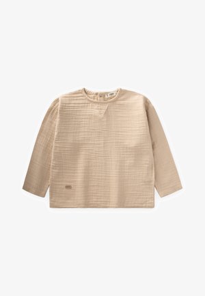 Beżowa bluzka z długim rękawem wykonana z fakturowanej tkaniny, z dekoltem w serek, opadającymi ramionami i małym logo na końcu.