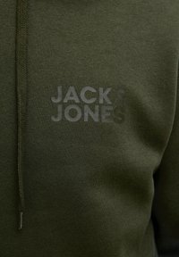 Khaki green hoodie with a textured, tonal logo "JACK & JONES" on the chest. Features a drawstring hood and soft, fleece-like fabric.