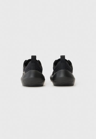 Black athletic shoes with a textured upper and padded collar, featuring a durable rubber sole and pull tabs at the back for easy wear.