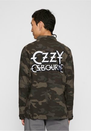 Camo jacket in dark green and brown, featuring a large white embroidered "Ozzy Osbourne" logo on the back, with buttoned cuffs.