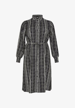 Robe à motifs noir et blanc avec des manches longues, un col, et une taille cintrée. Texture lisse et design mi-long.