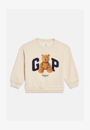 Crèmekleurige peutertrui met een teddybeer tussen grote, gestructureerde marineblauwe letters "G" en "P" en het woord "Original" eronder.