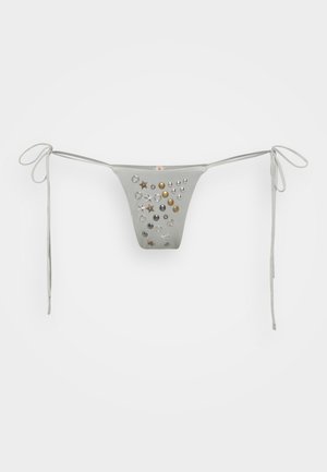Silver bikini bottom with a triangular shape, featuring various metallic embellishments like stars and circular studs, and tie side straps.