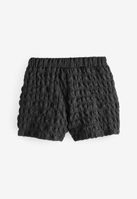 Pantalones cortos negros con una superficie texturizada y arrugada, que cuentan con una cinturilla elástica. Ajuste holgado, longitud corta y sin acentos adicionales.