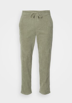 Khaki Cord-Jeans mit einem elastischen Bund, verstellbarem Kordelzug und geraden Beinen. Besitzt eine ausgeprägte gerippte Textur im gesamten Stoff.