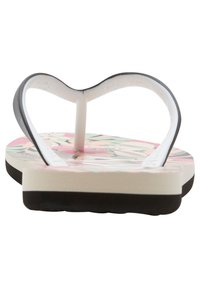 Infradito con motivo floreale in rosa e verde su una suola bianca e nera; suola piatta con design a cinghia e finitura testurizzata.