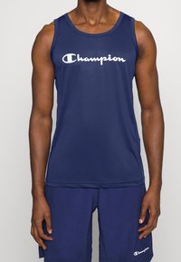 Navy blue athletic tank top made of breathable fabric featuring a prominent white "Champion" logo across the chest. Plain design, sleeveless.