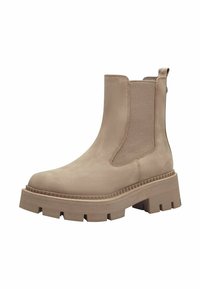Beige ankle boot with elastic side panels, textured suede material, and a chunky rubber sole with ridges for traction.