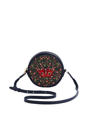Round navy crossbody bag with long adjustable strap, featuring embroidered red butterfly and floral design on front.