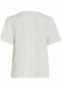 Blouse blanche à manches courtes avec un empiècement texturé et brodé, offrant une coupe ample. Le dos possède un détail froncé pour plus de fluidité.