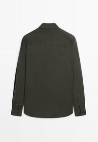 Langsleeve shirt in donkergroene stof, met een kraag, knoopsluitingen bij de mouwen en een gebogen zoom. De achterkant toont een eenvoudige, gladde textuur.