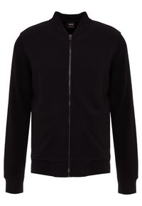Giacca bomber nera con zip frontale, colletto e polsini a costine. Tessuto liscio e design aderente, con dettagli in rete ai lati.