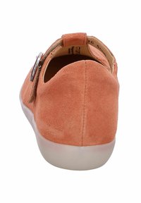 Orange suede shoe with a rounded toe, back strap, and silver accent. Features a white rubber sole and a smooth interior lining.