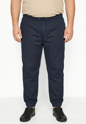 - Spodnie materiałowe