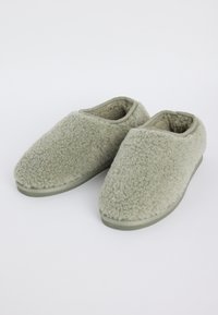 Soft, light gray fuzzy slippers with closed toes and low slip-on backs, placed side by side on a plain white background.