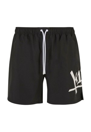 Sorte badeshorts med snøre i taljen, der har et stort hvidt grafisk design på venstre ben og sideslids ved kanten.