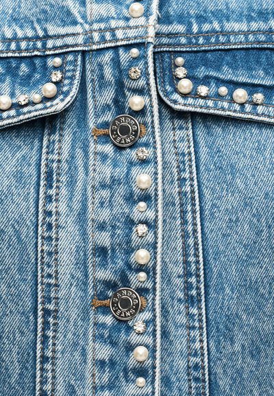 Φωτεινό γαλάζιο τζιν μπουφάν με μπροστινά μεταλλικά κουμπιά και διακοσμητικά στρας και πέρλες στις τσέπες και στη σειρά των κουμπιών.