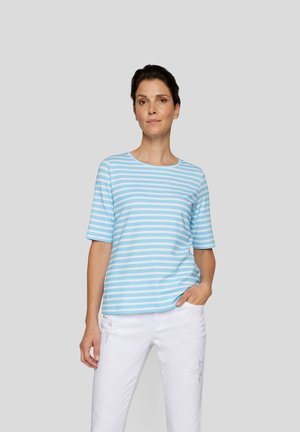 Light blue striped t-shirt with short sleeves, round neckline, and soft texture. Paired with white pants, featuring subtle details.