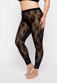 Zwarte kanten leggings met bloemenpatroon, semi-doorzichtig ontwerp, brede tailleband en enkel-lange pasvorm. Zachte textuur, flexibel materiaal.
