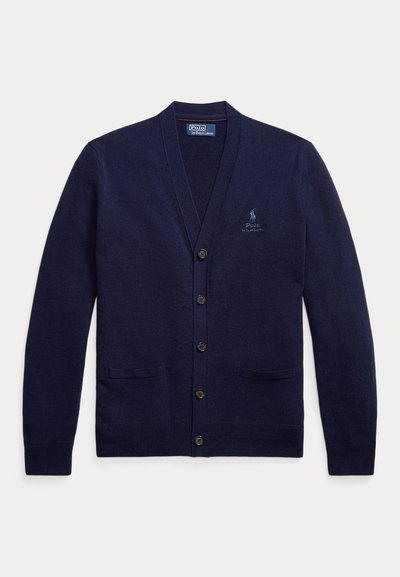 Cárdigan azul marino hecho de un suave tejido de punto. Presenta un escote en V, seis botones, dos bolsillos frontales y un logo bordado en el pecho.