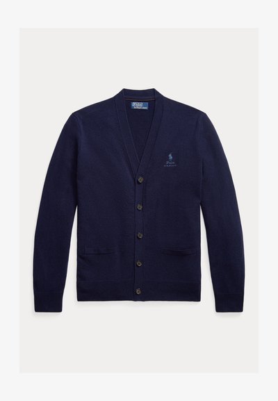 Cárdigan azul marino hecho de un suave tejido de punto. Presenta un escote en V, seis botones, dos bolsillos frontales y un logo bordado en el pecho.