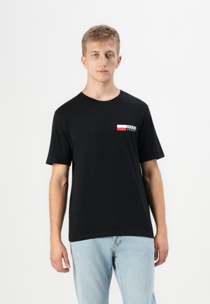 Black cotton t-shirt featuring a small white and red "JACK & JONES" logo on the left chest. Short sleeves and crew neck design.