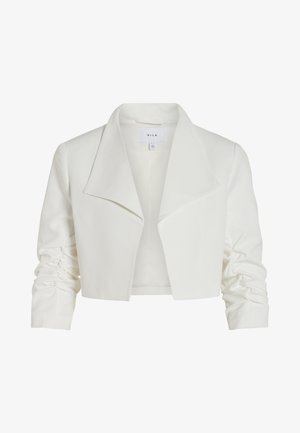 Veste blanche courte avec un col surdimensionné, des manches froncées et une texture de tissu lisse. L'étiquette à l'intérieur indique "VILA."