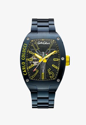 Blue stainless steel watch with a black face, yellow accents, large numbers, and a transparent back, featuring intricate patterns.