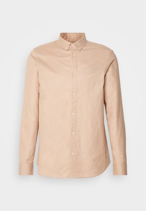 Licht beige button-up shirt van katoen met lange mouwen, een smalle kraag en een klein logo op de borst. Glad textuur, klassiek ontwerp.