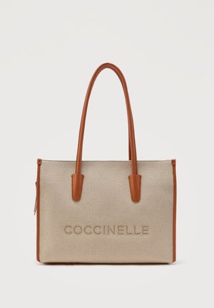 Μπεζ ορθογώνια τσάντα ώμου με καφέ δερμάτινες λαβές και επένδυση, με ανάγλυφο κείμενο "COCCINELLE" στη μέση μπροστά.