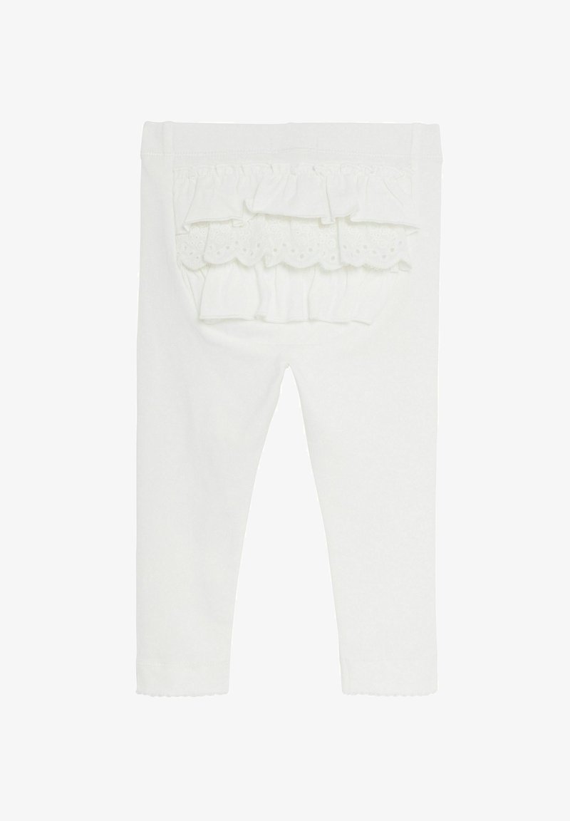 White cotton leggings with ruffled back pocket detail, featuring scalloped edging and a smooth texture. Ideal for casual wear.