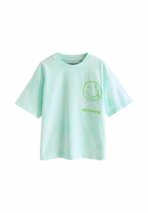 Grünes T-Shirt mit kurzen Ärmeln und rundem Ausschnitt, mit einer grünen lächelnden Gesichts-Grafik und dem Schriftzug "NIRVANA NEVERMIND" auf der Brust.