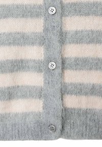 Nahaufnahme eines kuscheligen, gestrickten Cardigans mit horizontalen cremefarbenen und grauen Streifen, ausgestattet mit einer Knopfleiste mit drei grauen Knöpfen.
